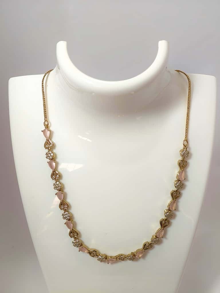 Designer necklace crystal clusters and teardrop-shaped stones in gold-tone base.